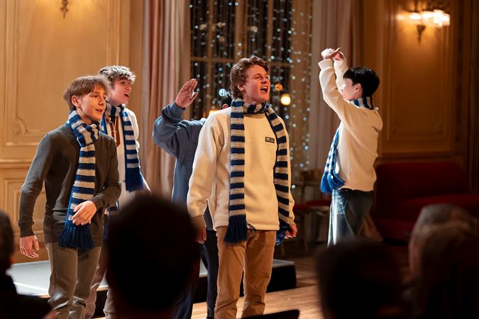 An group shot of boys singing in Grainger Ballroom from the Vernon Hills High School Chamber Choir