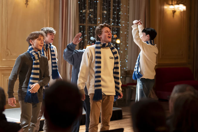 An group shot of boys singing in Grainger Ballroom from the Vernon Hills High School Chamber Choir