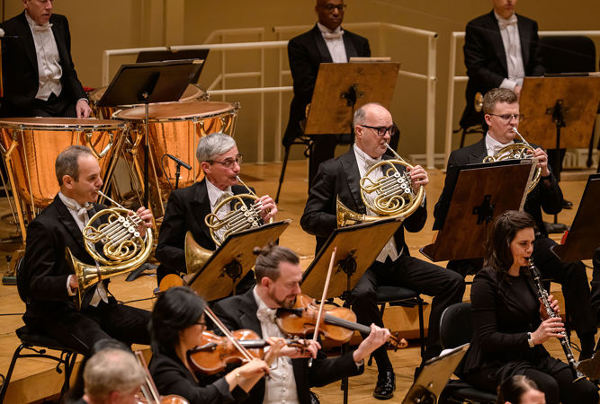 A group shot of CSO horns performing on stage