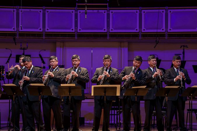 a composition of CSO assistant principal clarinet John Bruce Yeh performing in eight different positions on stage