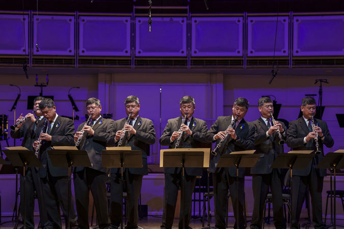 a composition of CSO assistant principal clarinet John Bruce Yeh performing in eight different positions on stage
