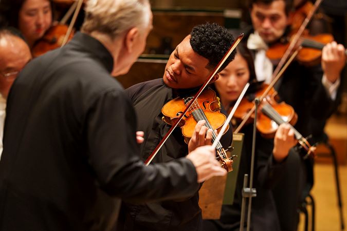 Closeup action shot of violinist Randall Goosby