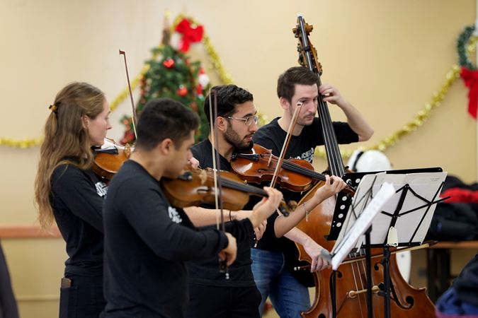 Civic violinists and a bass player performing a piece from their Bach Marathon program at the Southwest Regional Senior Center