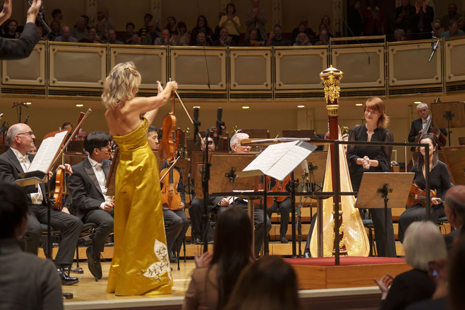soloist acknowledging orchestra