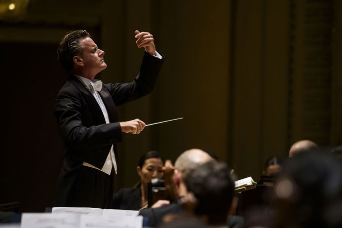 Closeup action shot of guest conductor Philippe Jordan leading the CSO