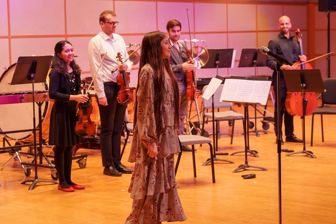 young composer standing for applause
