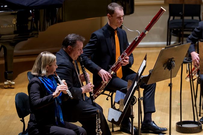 Closeup action shot of CSO musicians Emma Gerstein (flute), Stephen Williamson (clarinet) and Keith Buncke (bassoon)