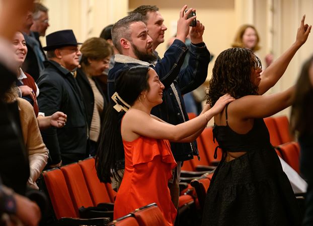 audience members form a conga line