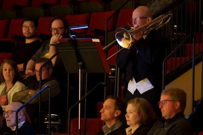 Close up of principal trombone Jay Friedman playing from the lower balcony
