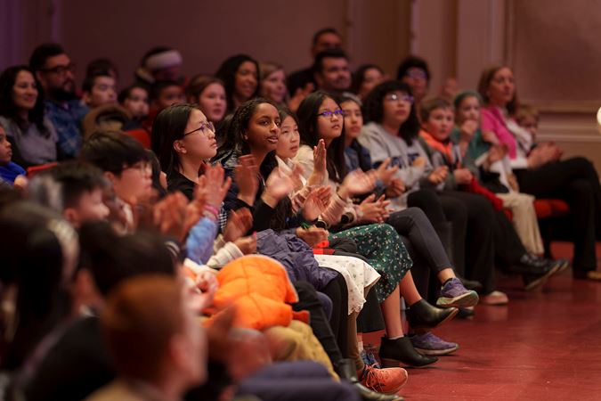 Students applauding members of the CSO on the main floor