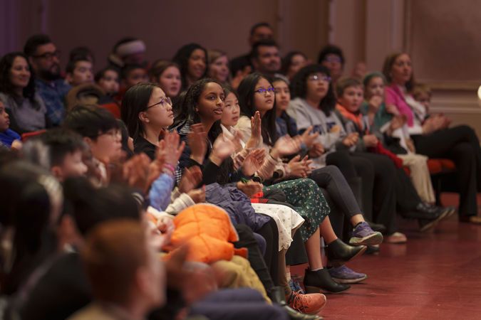 Students applauding members of the CSO on the main floor