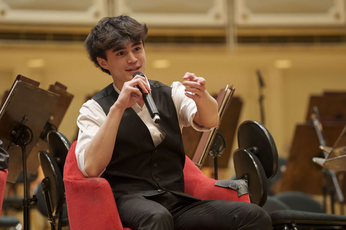 2025 Young Artists Competition finalist Joseph Gallwas speaking with the audience during a postconcert Q&A session