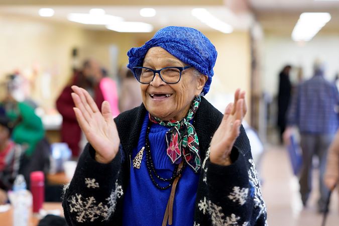 A community member from the Southwest Regional Senior Center applauding Civic musicians after their Bach Marathon concert