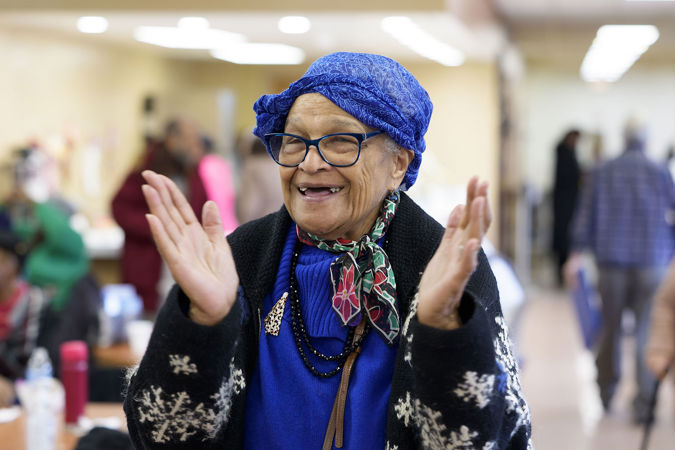 A community member from the Southwest Regional Senior Center applauding Civic musicians after their Bach Marathon concert