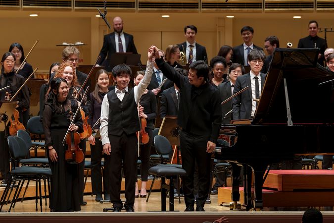 2025 Young Artists Competition winner Jeremy Liu bowing on stage after his performance with the Civic Orchestra of Chicago and conductor Jerry Hou