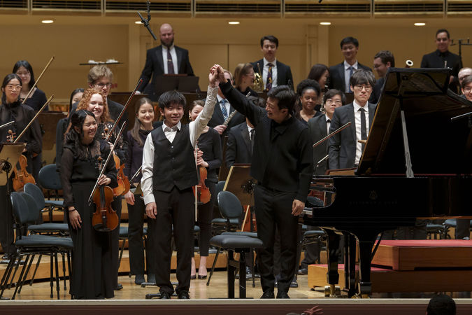 2025 Young Artists Competition winner Jeremy Liu bowing on stage after his performance with the Civic Orchestra of Chicago and conductor Jerry Hou
