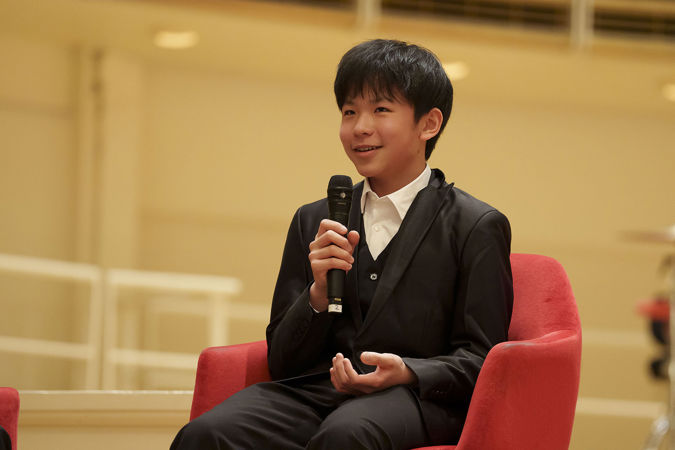 2025 Young Artists Competition winner Jeremy Liu speaking on stage at a postconcert Q&A session