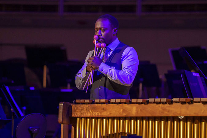 Closeup of Percussion Scholarship Program alum Josh Jones tearing up while the audience applauses