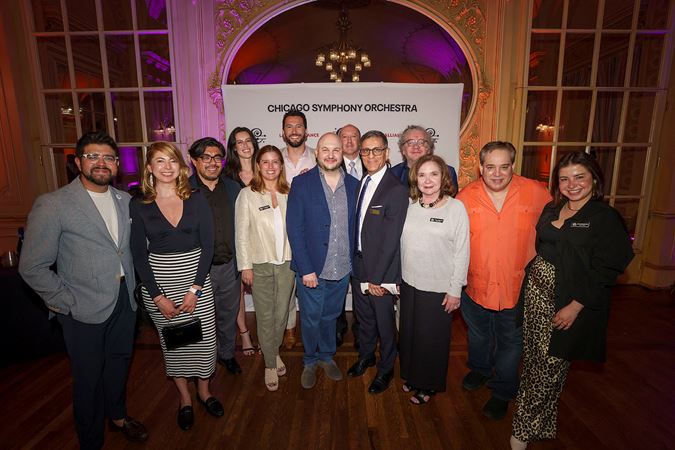 A group shot of several Latino Alliance members and CSO principal trumpet Esteban Batallán