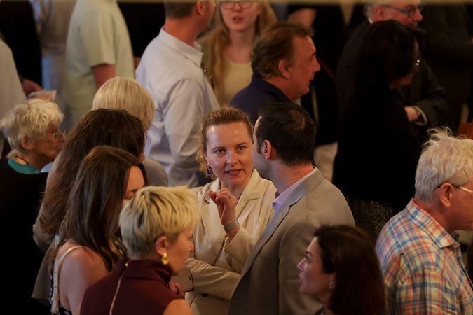 audience members talking in lobby