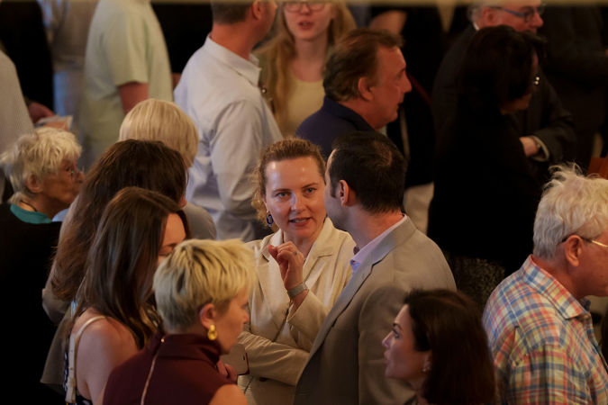 audience members talking in lobby
