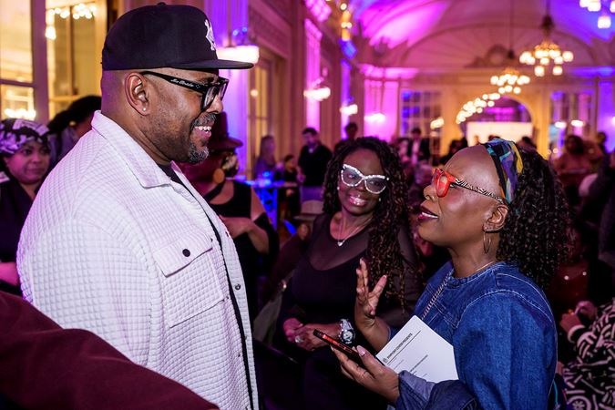 Christian McBride greets two enthusiastic fans at the African American Network postconert celebration