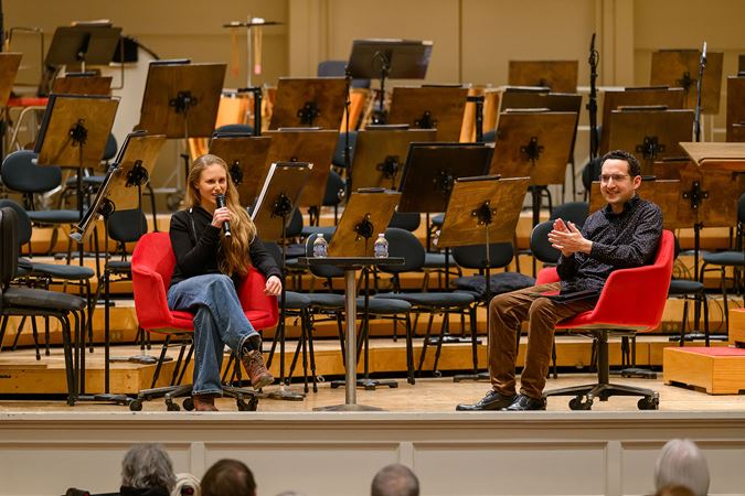 composer Gabriella Smith and scholar Daniel Schlosberg speak during a preconcert lecture on stage in Orchestra Hall