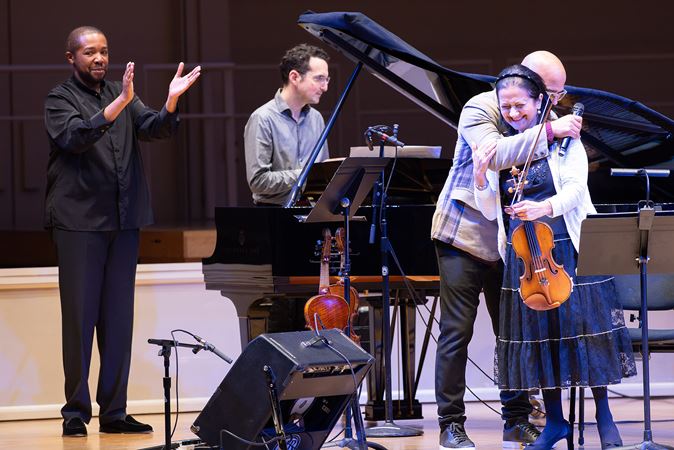 the performers hug and give a bow