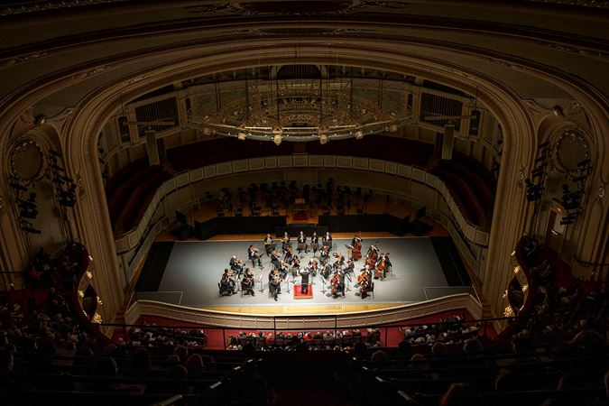 A wide shot of the CSO and Harry Bicket from the Flynn Gallery