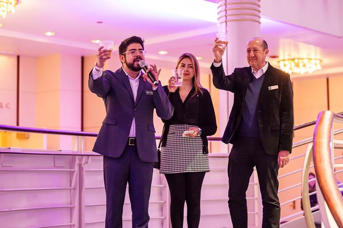 three CSO Latino Alliance board members raise their glasses in a toast to the artists