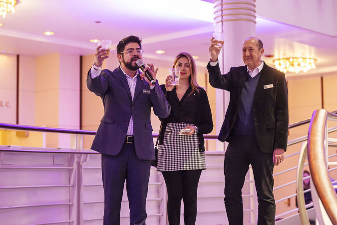 three CSO Latino Alliance board members raise their glasses in a toast to the artists