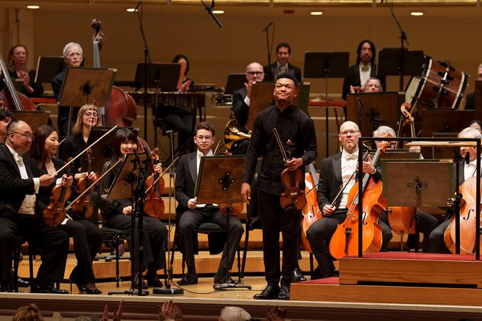 Closeup shot of violinist Randall Goosby bowing after his debut performance of Florence Price's Second Violin Concerto