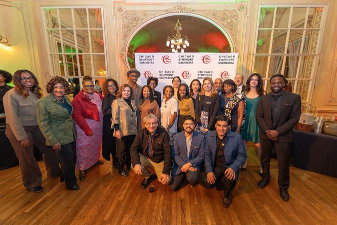 members of the CSO Latino Alliance and African American Network pose together at a postconcert event.
