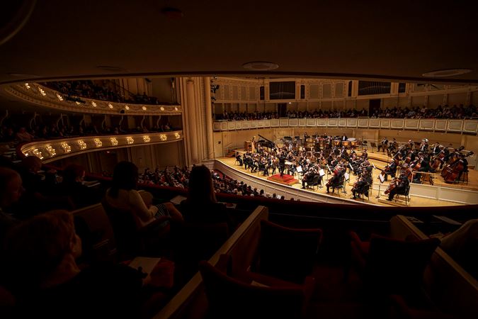 a point of view from the right side of the box level of the full Orchestra performing Dvořák's American Suite