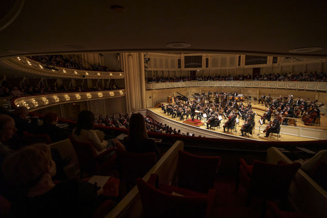 a point of view from the right side of the box level of the full Orchestra performing Dvořák's American Suite