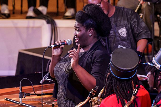 Closeup of a woman speaking on stage.