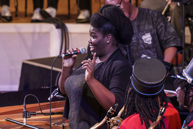 Closeup of a woman speaking on stage.