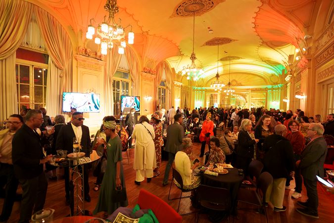 African American Network members and guests mingle in the beautiful Grainger Ballroom, awash in green, red and yellow lighting