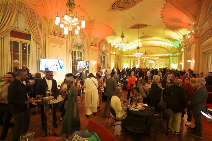 African American Network members and guests mingle in the beautiful Grainger Ballroom, awash in green, red and yellow lighting