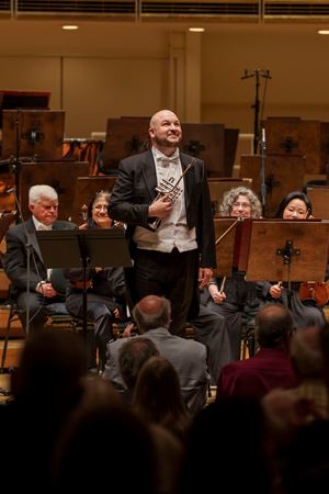 CSO principal trumpet Esteban Batallán bowing on stage
