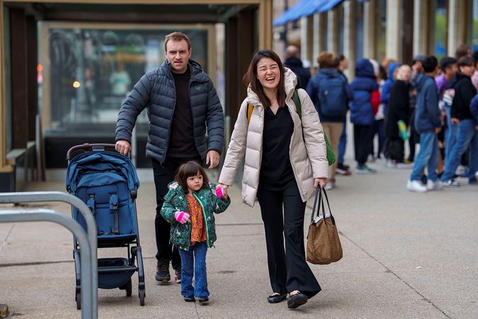 A family smiling and walking to Symphony Center on Michigan Avenue
