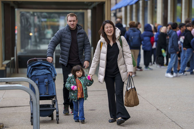A family smiling and walking to Symphony Center on Michigan Avenue
