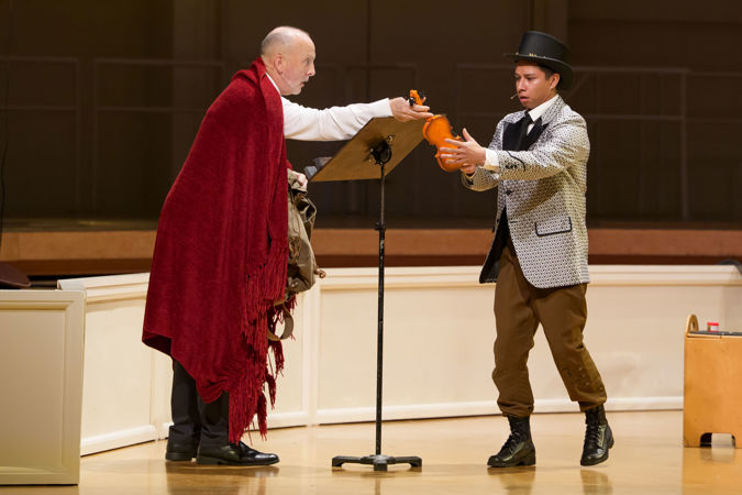 Closeup action shot of actors (the devil and the soldier) from The Goodman performing The Soldier's Tale on stage with the CSO