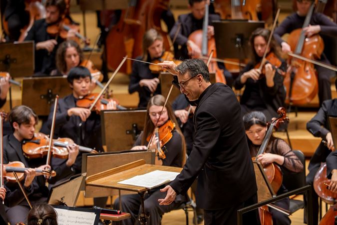 Closeup action shot of principal conductor Ken-David Masur conducting the Civic Orchestra of Chicago