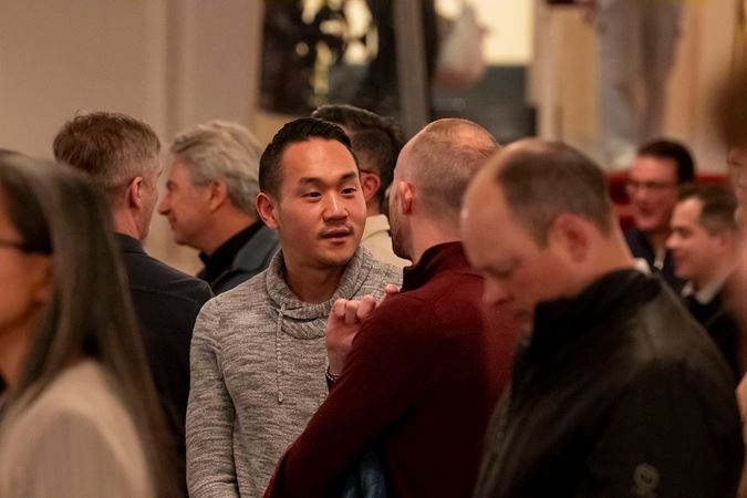 the audience mills about in the lobby