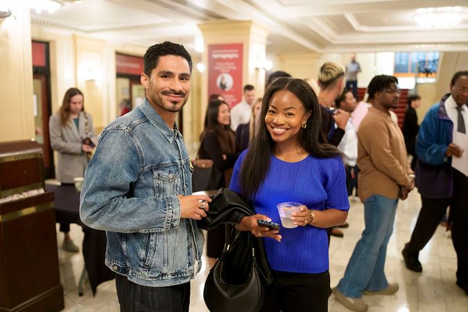 Two patrons smiling near the Main Floor lobby concessions counter.
