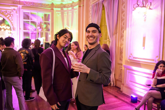 Two Underground attendees smiling at the camera in Grainger Ballroom
