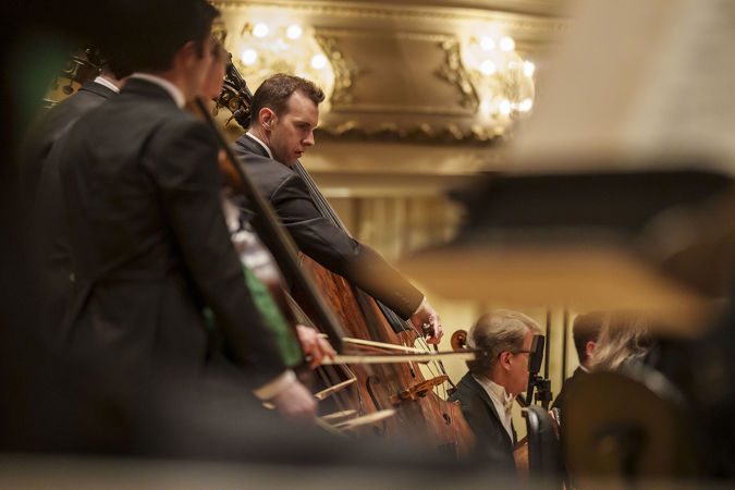 CSO principal bass Alexander Hanna focuses on a passage of music, bow in hand