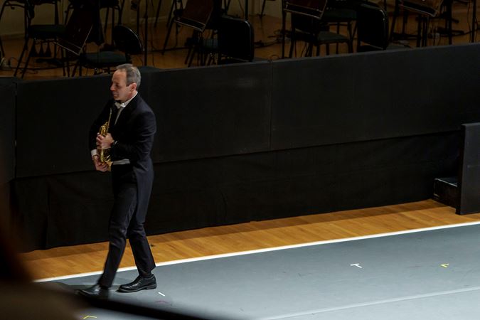 Horn player Oto Carrillo walks off stage during the last movement of Haydn's Farewell Symphony
