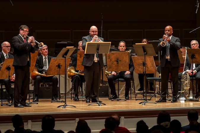 a trumpet trio performs